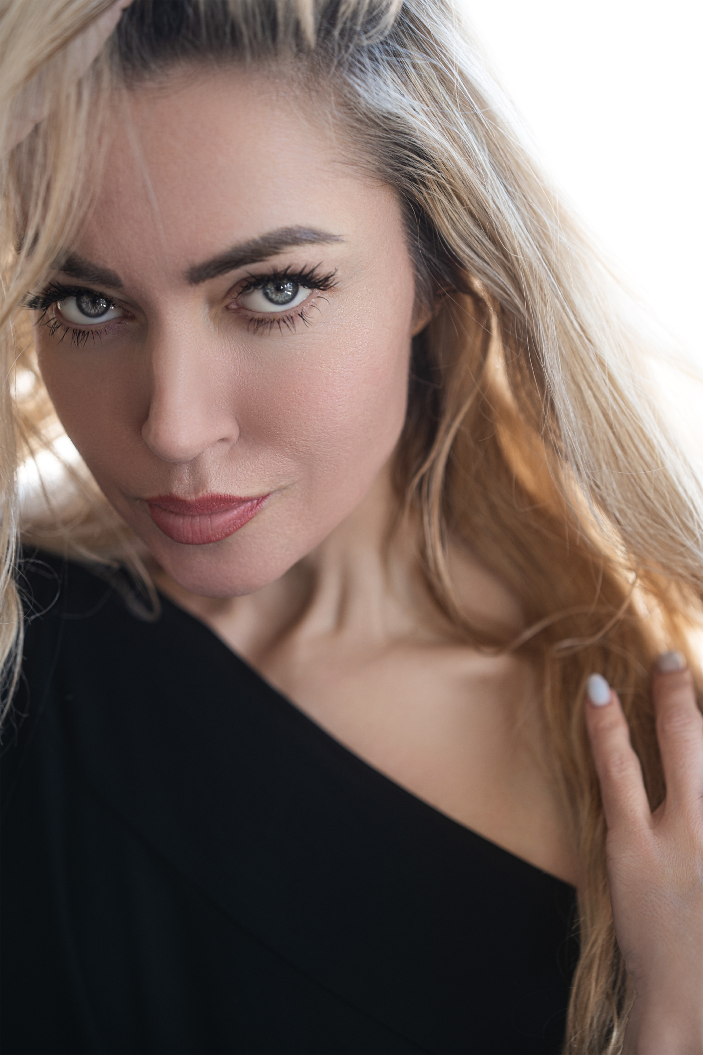 Aurora: a close portrait of a blonde woman in soft natural light
